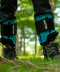 Steel Tree Climber Gaffs With Ergonomic Shank And 20 Plus Cuff Adjustment Points in use in a forest setting