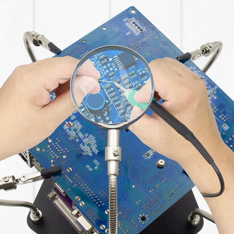 Helping Hand Soldering Third Hand Tool With Flexible Arms and Soldering Iron Stand holding PCB for electronic repair.