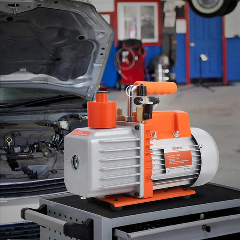 VEVOR 7 CFM dual-stage HVAC vacuum pump with oil bottle, orange housing.