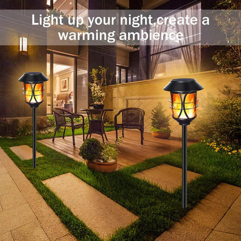 Outdoor Solar Flame Lights Metal Stakes Flickering Torch Style Garden Path Lights illuminating patio at night