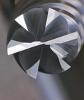 Close-up of a 6-flute carbide end mill with 1/4 in shank; silver cutting tool for alloy steels and cast iron