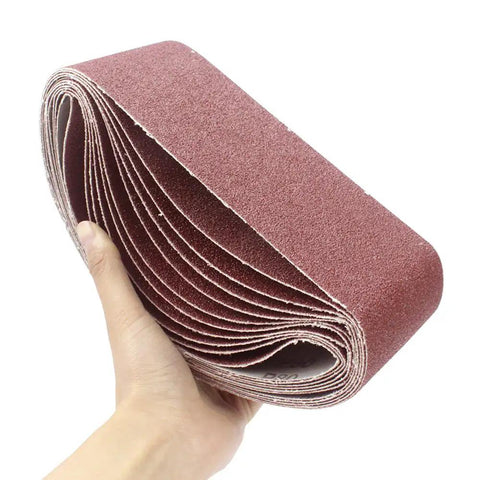 Person holding Rugged 3X21 Inch Sanding Belts, 12 Pack 80 Grit Aluminum Oxide Open Coat ideal for woodworking and belt sanders