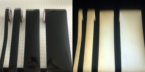 Straight Up Black Engineer Grade Reflective Tape That Goes Hard On Worksite Safety For Pipes And Bollards Smooth Flat Or Round Surfaces With Peel Off Acrylic Backing displayed in rolls.