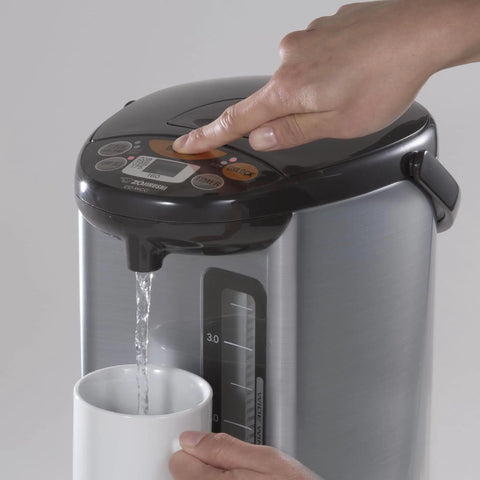 Micom Water Boiler And Warmer With 4 Liter Capacity 135 Oz Silver Finish Micro Computerized Temperature Control being used to fill a cup