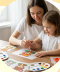 Mother and daughter using 161 Piece Shrink Plastic Keychain Making Kit With 30 Sheets to paint animal designs