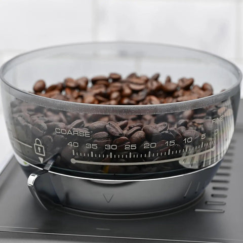 Fully Automatic Espresso Machine With Badass Burr Grinder And Hella Smooth Pulls Featuring Precise Temperature Control Plus Adjustable Milk Frother And Pro Grade 58mm Portafilter For Kitchen Ready Barista Coffee with coffee beans in a transparent bowl.