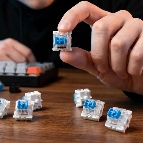 Blue 3-Pin Clicky Mechanical Keyboard Switches 50gf Actuation, Tactile And Audible Feedback, 30-Piece Bulk Pack For DIY Keyboards, Gaming, Typists, And Fidget Enthusiasts held in hand