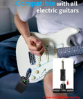 Person using Compact 5W Practice Guitar Amp with Bluetooth and rechargeable battery, plugged into electric guitar, extension plug shown.