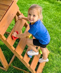 Child climbing wooden ladder on Wooden Backyard Playset With Monkey Bars And Wave Slide For Kids Ages 3 To 6 Includes 2 Belt Swings
