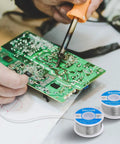 Top Shelf 63 37 Tin Lead Solder Wire With Rosin Core Flux 0.6 Mm Diameter 100 Gram Roll used in electronics repair on circuit board.