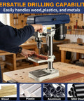 Kickass 8 Inch Benchtop Drill Press With Heavy Duty Cast Iron Head, drilling wood on adjustable work table.