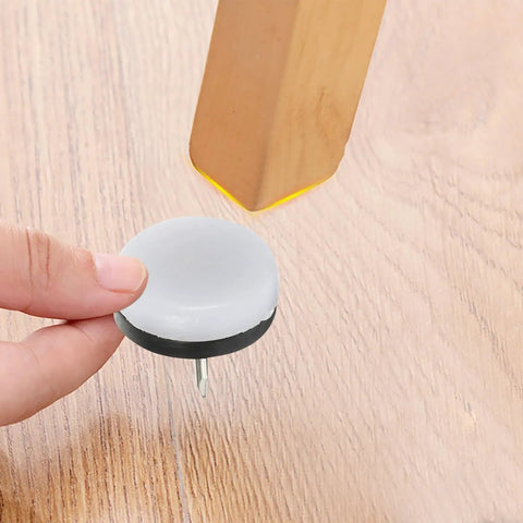 Holding a brown nylon furniture glide pad with steel pin for round chair legs, part of 40 Pack Brown Nylon Furniture Glide Pads With Steel Pins For Round Chair Legs Floor Protectors That Reduce Noise And Protect Hardwood Tile Laminate Floors At Home Office Kitchen.