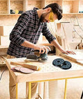 Ditch Your Old Pads And Grab 4 Premium Hook Loop Sanding Backing Discs For Orbital Sanders, used by man sanding wood.