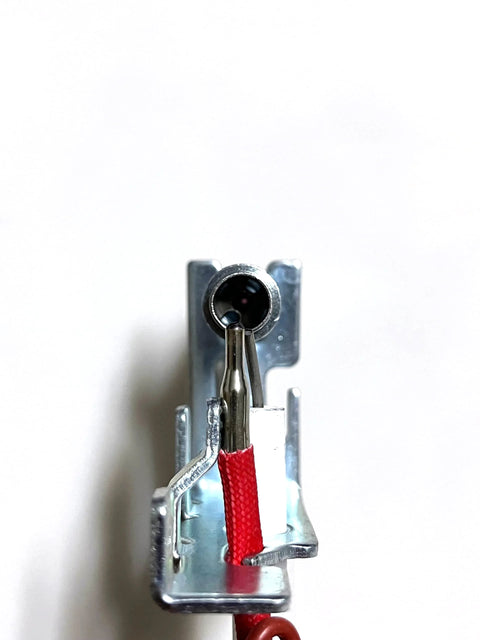 Natural gas pilot assembly for vent-free heater; red insulated lead and metal mounting bracket, front view