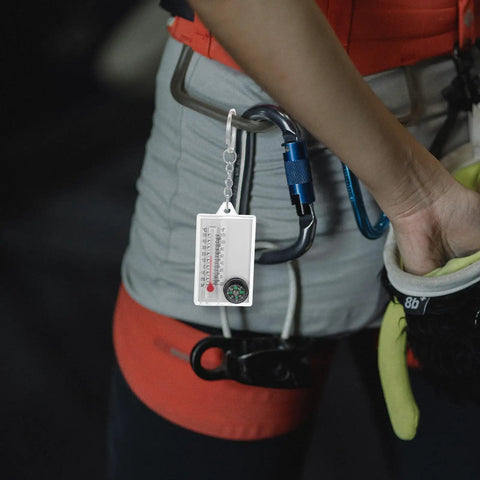Two Pack Portable Keychain Compass With Thermometer Wear Resistant Mini Pocket Navigator attached to a climber's harness