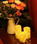 Flameless Wax Pillar Candles Set Of 3 Ivory With Embedded String Lights LED Battery Powered And 5 Hour Cycling Timer shown lit