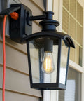 Outdoor Wall Lantern featuring Go-To Outdoor Wall Lantern 1 Light With Seeded Glass And Built In GFCI Outlet Black Finish on house siding