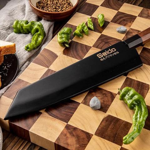 Kiritsuke Knife Cover With Walnut Magnetic Sheath For 10 Inch Blades displayed on wooden board with green peppers.