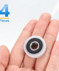 Slick 4 Pack Heavy Duty Roller Idler Bearing Pulleys 8X26X7MM White Pom Plastic Conveyor Wheels With Quiet 608RS Ball Bearings held in hand.