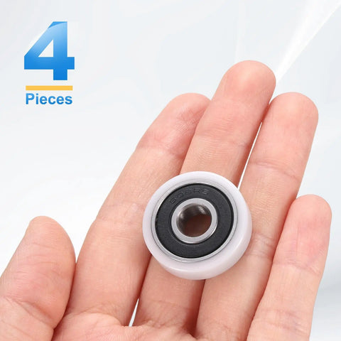 Slick 4 Pack Heavy Duty Roller Idler Bearing Pulleys 8X26X7MM White Pom Plastic Conveyor Wheels With Quiet 608RS Ball Bearings held in hand.