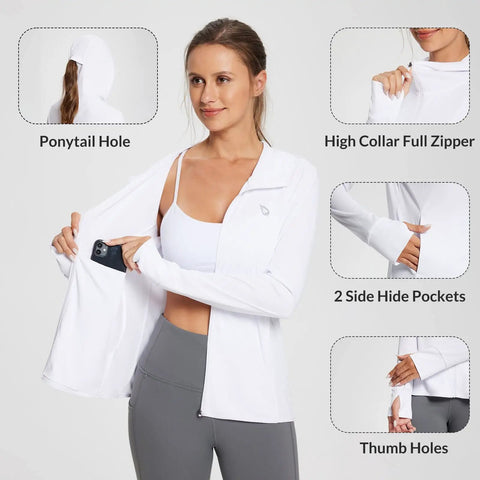 Woman wearing Women's UPF 50 Plus Sun Protection Hoodie Jacket For Hiking And All Day Outdoor Adventures Lightweight Long Sleeve With Hood And Thumbholes Breathable Quick Dry Fabric Ideal For Travel Fishing Beach White Size M with phone in pocket and thumbholes visible