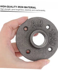 Hand holding a vintage iron floor flange from the Two Pack Vintage Malleable Iron Floor Flange Set for DIY projects.