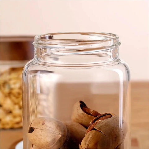 Slick High Borosilicate Glass Storage Jars With Acacia Wood Lids Gonna Keep Your Kitchen Fresh These Dope Food Canisters For Coffee Sugar Nuts Are Straight Up A Nifty Counter Top Setup with nuts inside.