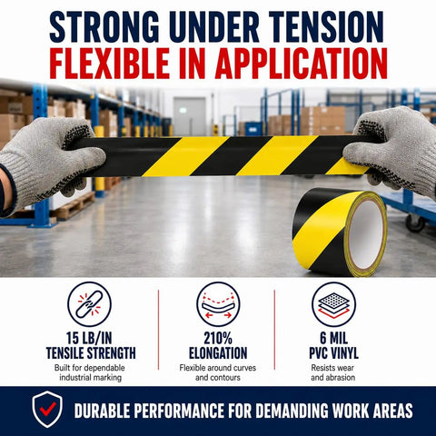Knockout Black And Yellow Hazard Stripe Tape For Floor Marking in hand, showcasing 6 mil PVC vinyl, flexible application in workspace.