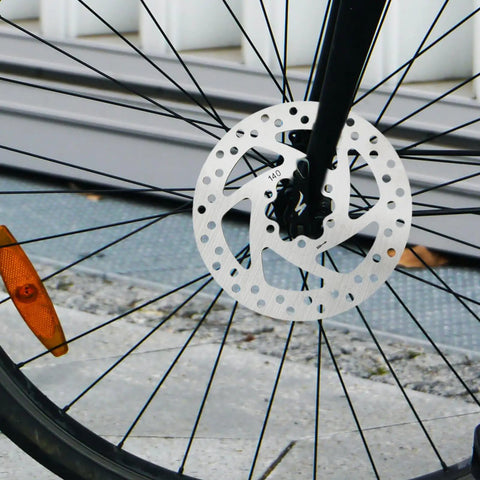 140mm 6-Bolt Stainless Steel Bike Disc Brake Rotor For Road, Mountain, BMX And Electric Scooters, attached to bicycle front wheel