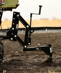 New Soil Kit For ATV UTV And Tractors Includes 1 Point Lift Cultivator Disc Plow And Middle Buster in action on a muddy field.