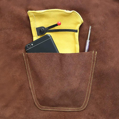 Pocket of leather welding work apron with heat and flame resistant cowhide leather, heavy duty BBQ apron, brown, tools inside.