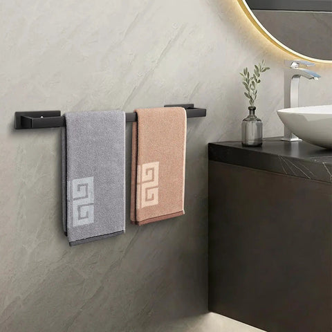 Stick On Stainless Steel Towel Bar 24 Inch Matte Black No Drill Wall Shelf Rack Hang On Towel Holder with towels in bathroom.