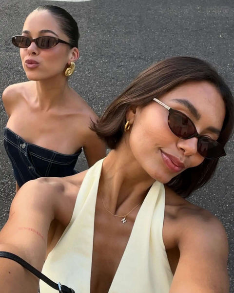 Two women wearing retro oval sunglasses for women with cat eye 90s vibe lightweight narrow frames UV protection sun glasses.