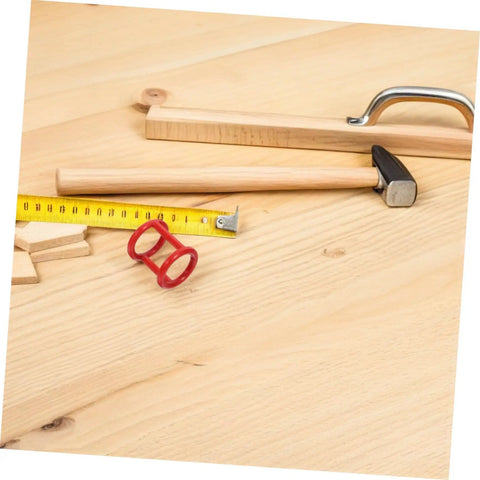 Woodworking tools and accessories on a wooden workbench, including a hammer, measuring tape, and handle