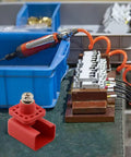 Tough As Nails 200 Amp Lithium Terminal Connector With Threaded Wiring and High Voltage Power Adapter For EV Battery Packs Red pure copper connector on workbench.