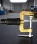 Dope Heavy Duty Grounding Clamp With Screw For Welders And Workshops Featuring Secure Insulated Handle, gold and black, with serrated jaws.
