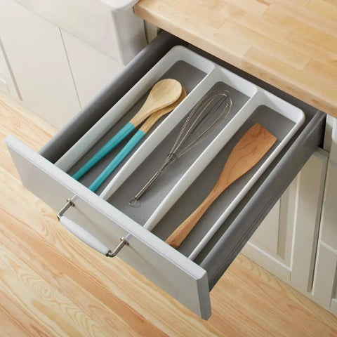 Open drawer with three compartment utensil tray for kitchen drawers with deep storage and non slip lining, holding spoons and whisk.