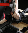 Person using Nine Piece Roll Pin Punch Set Pro Grade With Durable Heat Treated Drop Forged Steel Pins on a gun for repair