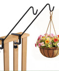 Badass Deck Railing Plant Hangers 2 Pack Workhorse Solid Core Shepherd Hooks Rust Resistant holding flower pot on wood fence.