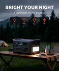 Rock Solid 1800W Portable Power Station Featuring 1024Wh LiFePO4 Battery And 100W Solar Panel lit at night on a camping table.