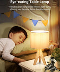 Child sleeping beside Boho Table Lamp Set Of 2 With Wooden Tripod Bases, Grey Linen Fabric Shades; cozy bedside nursery lamp.