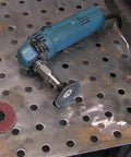 Five Eighth UNC Thread Adapter With One Quarter Inch Collet For Angle Grinders with attached grinding wheel on metal table