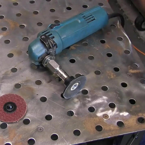 Five Eighth UNC Thread Adapter With One Quarter Inch Collet For Angle Grinders with attached grinding wheel on metal table
