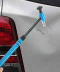 Pro Grade Multi Head Paintless Dent Removal Hammer Kit used on car door to fix dents with blue alloy tool.