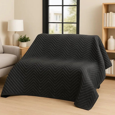 Essentials Moving Blanket 40x72 Pro Quilted Furniture Pad For Movers And Packers draped on a sofa in a living room setting.