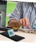 Tech professional using Antistatic Bar Rack Organizer For Circuit Boards with Grounding Tape Wrist Strap in a workshop setting.