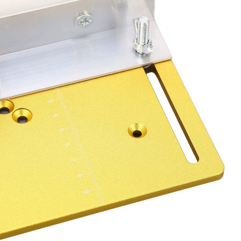 Close-up of Solid As Rock Aluminum Router Table Insert Plate showing ruler marks, precision spacers, and gold tone finish.