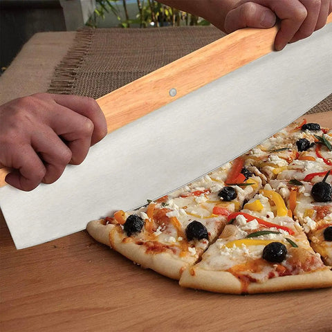 Using the steel pizza cutter from the 4 Piece Rectangle Pizza Stone Set 15 Inch For Oven And Grill With Oak Pizza Peel to slice pizza.