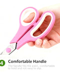 Three Pack Colorful 8 Inch Stainless Steel All Purpose Scissors With Go-To Ultra Sharp Blades And Comfort Grip Handles In Green Purple Orange For School Office Home Sewing Craft Projects. Pink comfort grip scissors held in hand