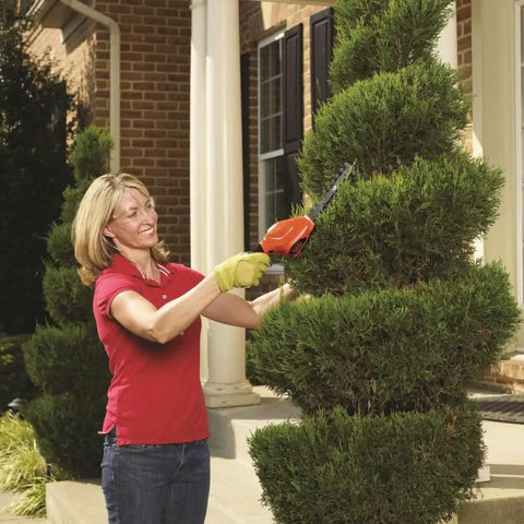 Person using Cordless Shrub Trimmer And Grass Shear Combo, Lightweight Three Point Six Volt Lithium Battery, Easy Grip, Low Emission Yard Tool for pruning.